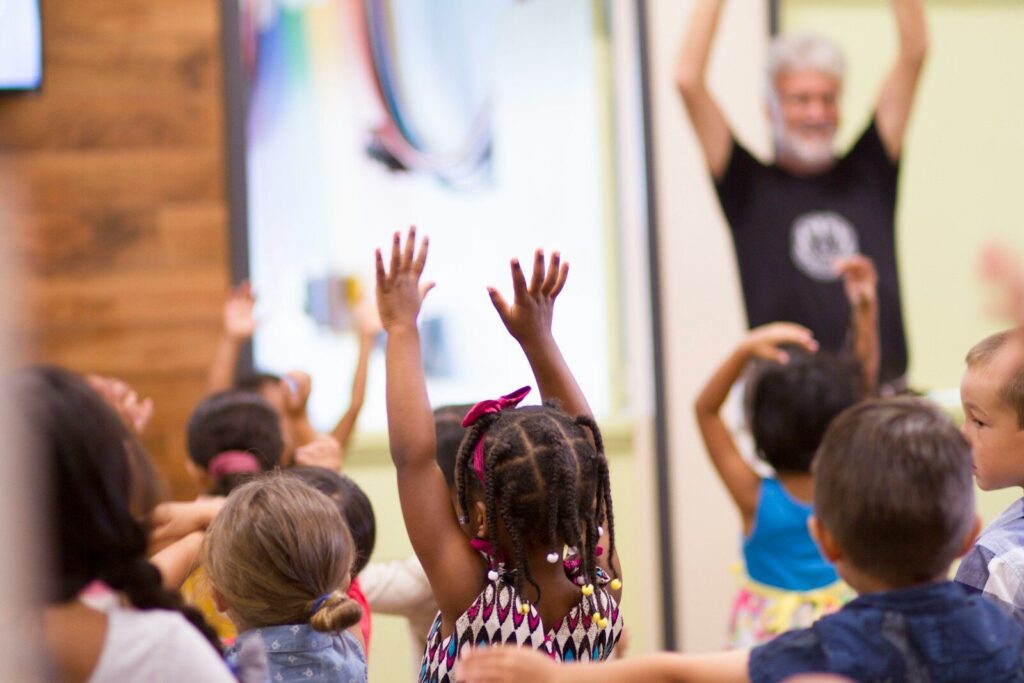 children lifting hands